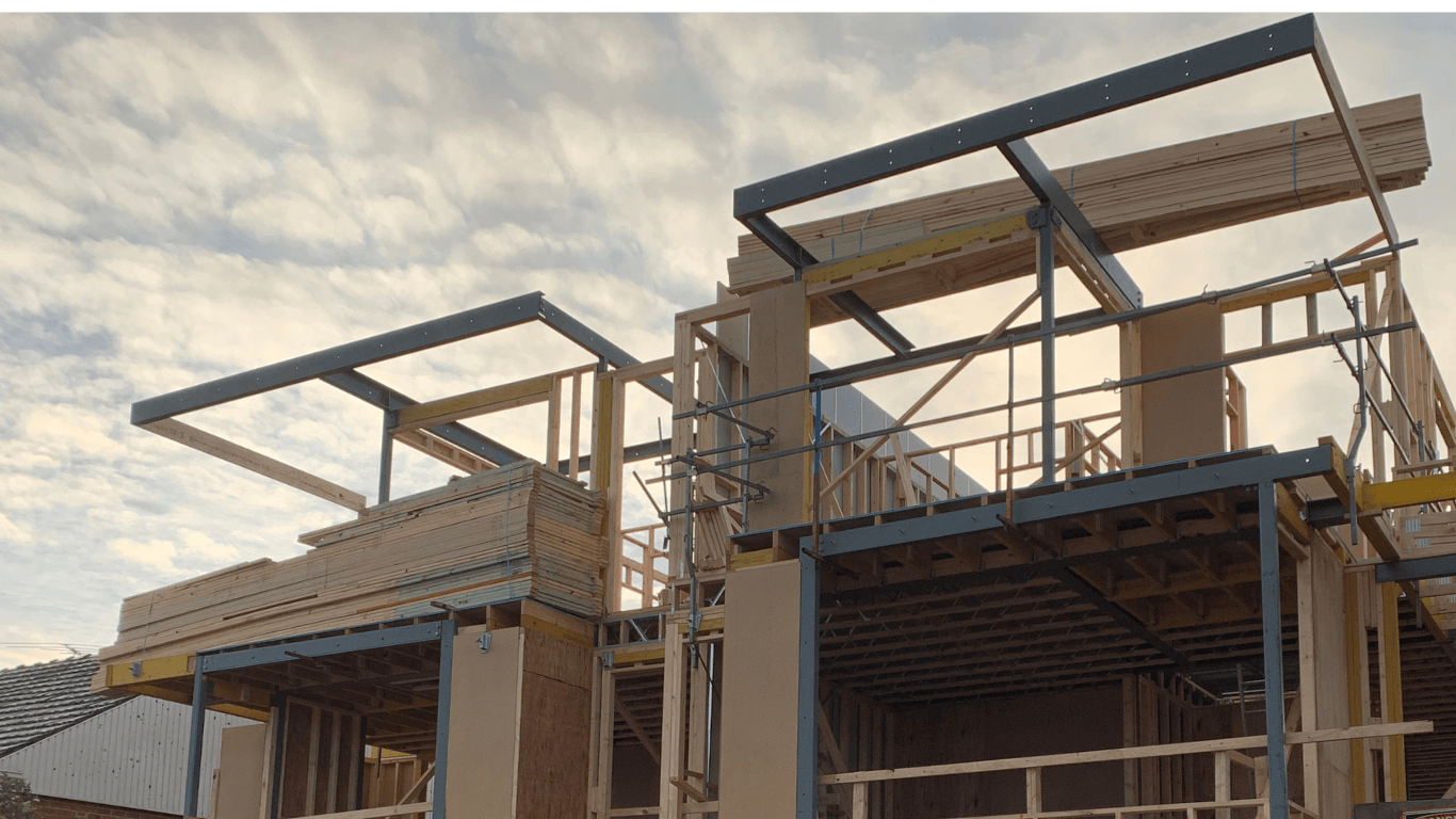 Timber framing and structural steel during early-stage residential construction