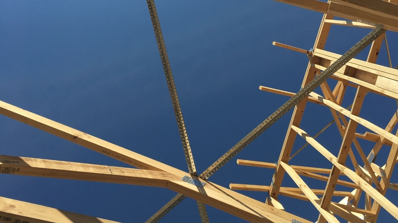 Timber roof framing during early construction, showing where supplier decisions are locked in early